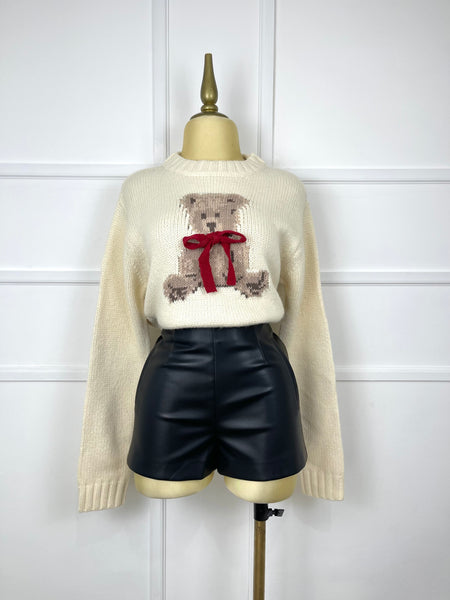 Suéter beige tejido con oso