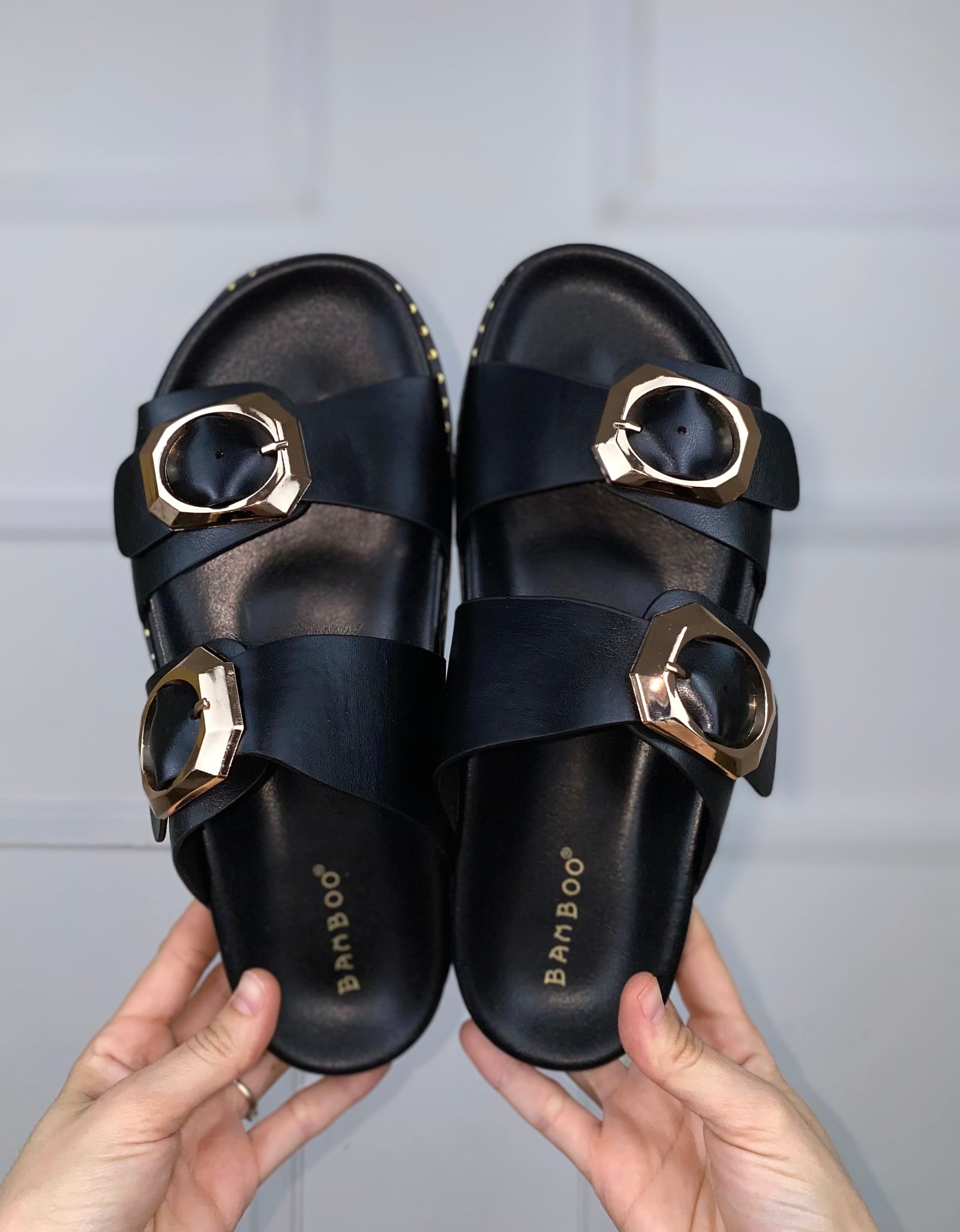 Sandalias negras con hebillas doradas